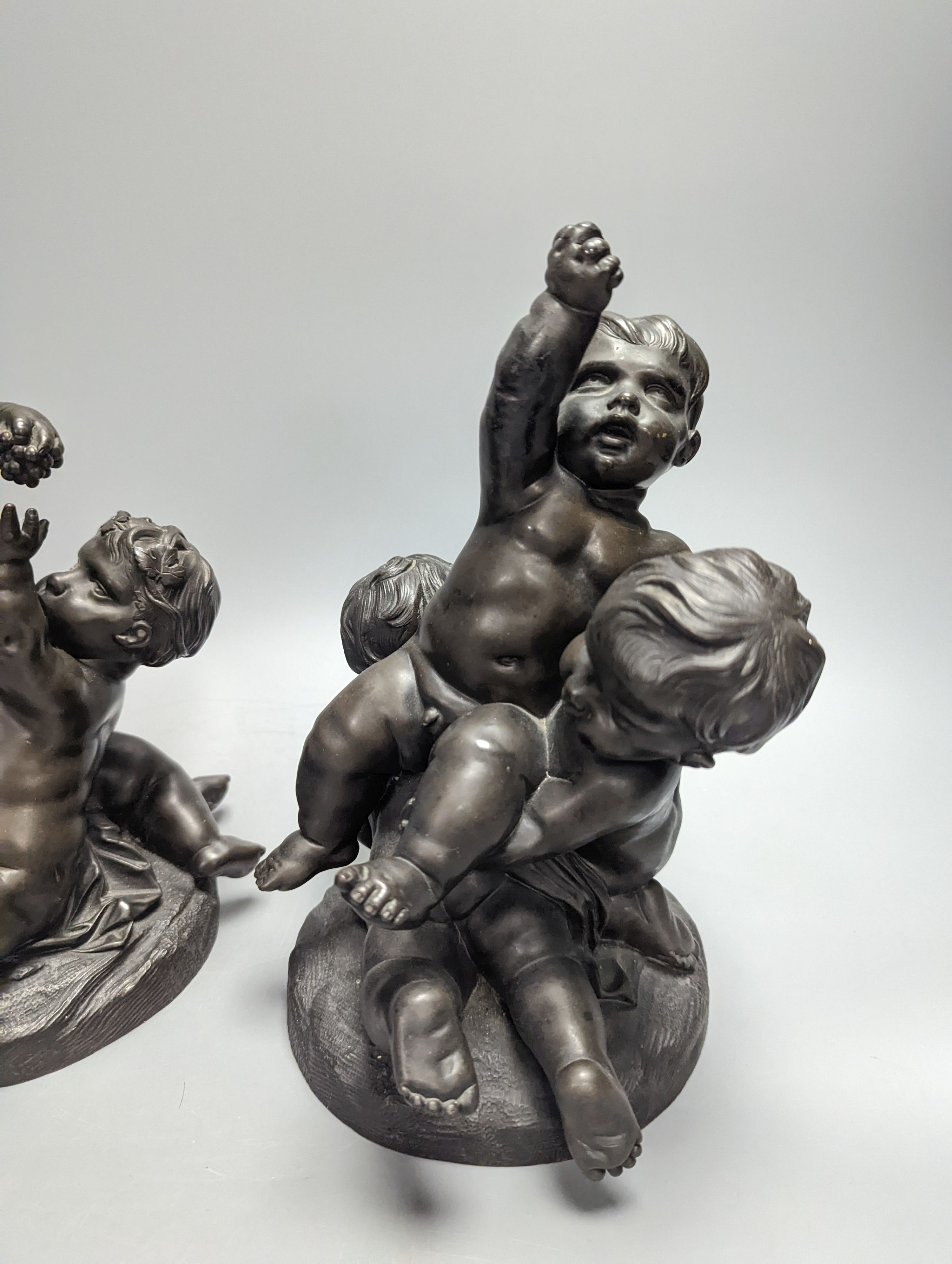 After Clodion, a pair of early 20th century bronze groups of putto, tallest 25cm